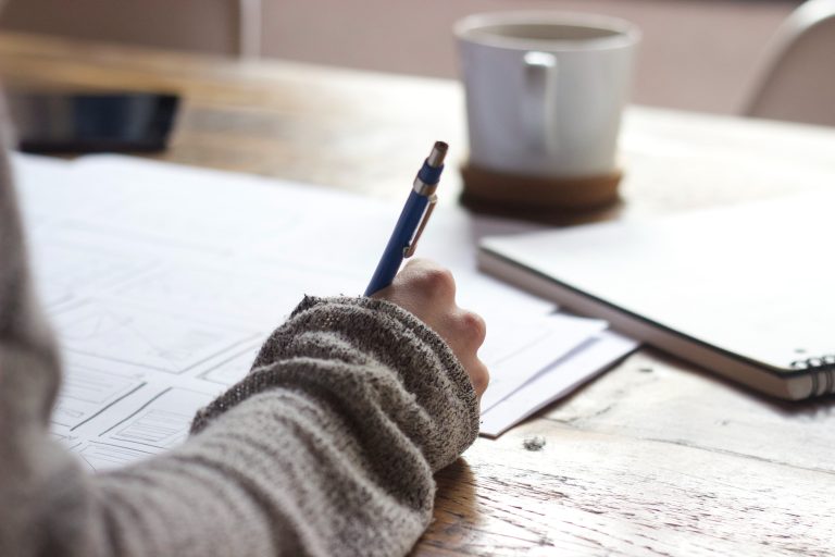 Write it down. Person writing with a pen.