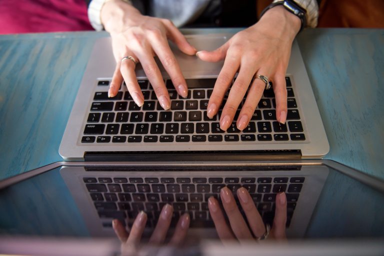 Goal Setting Tips Typing on Laptop
