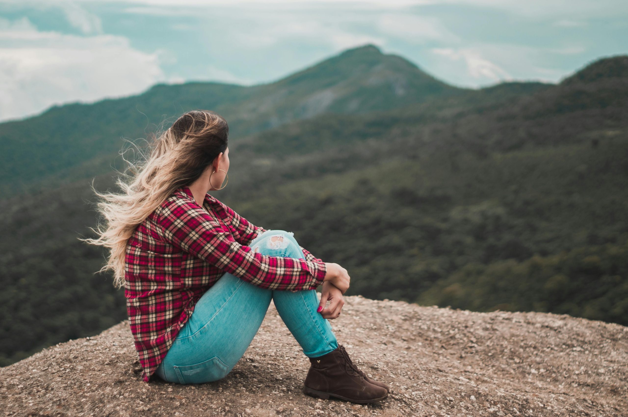 Woman looking at mountains and thinking
