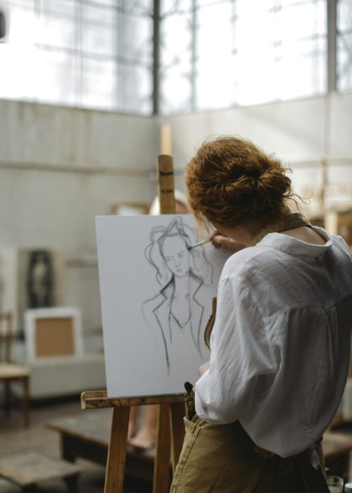 Woman painting portrait. Promote yourself at work.